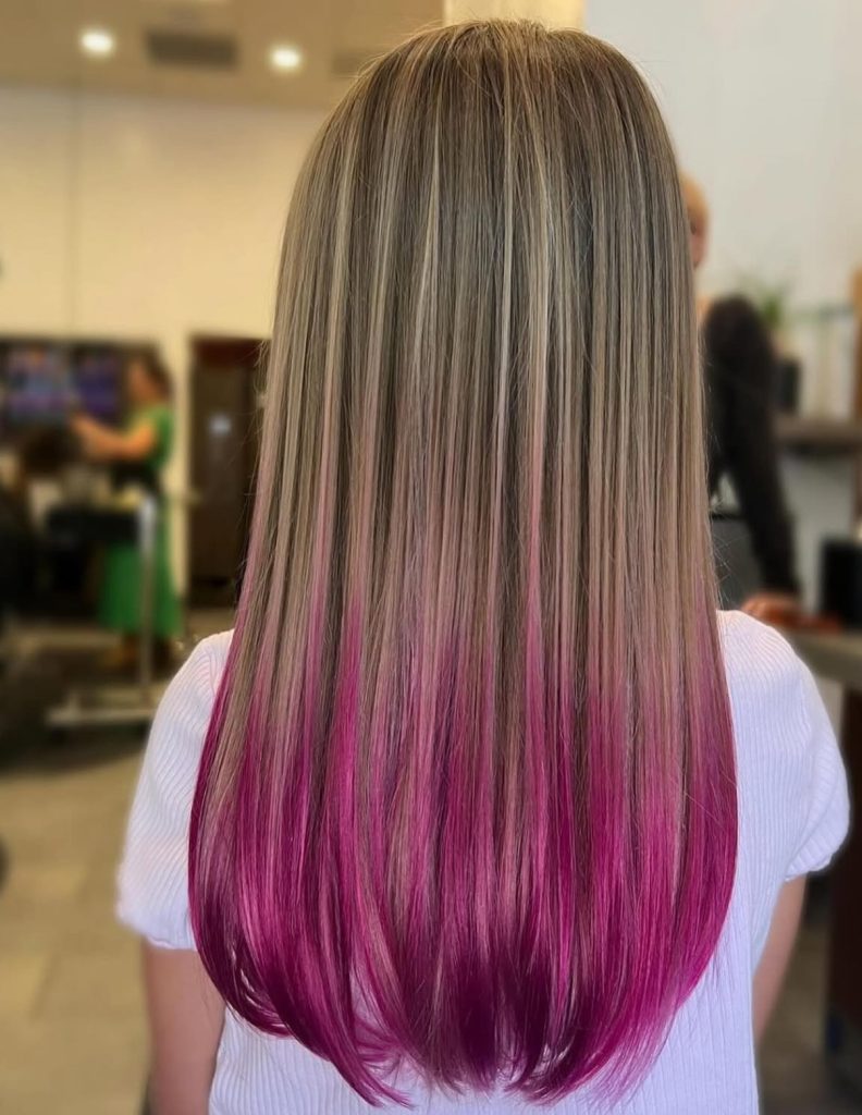 Person with straight, long hair featuring blonde highlights and vibrant pink tips, wearing a white shirt in a salon setting. - Atelier Studio, San Jose, CA